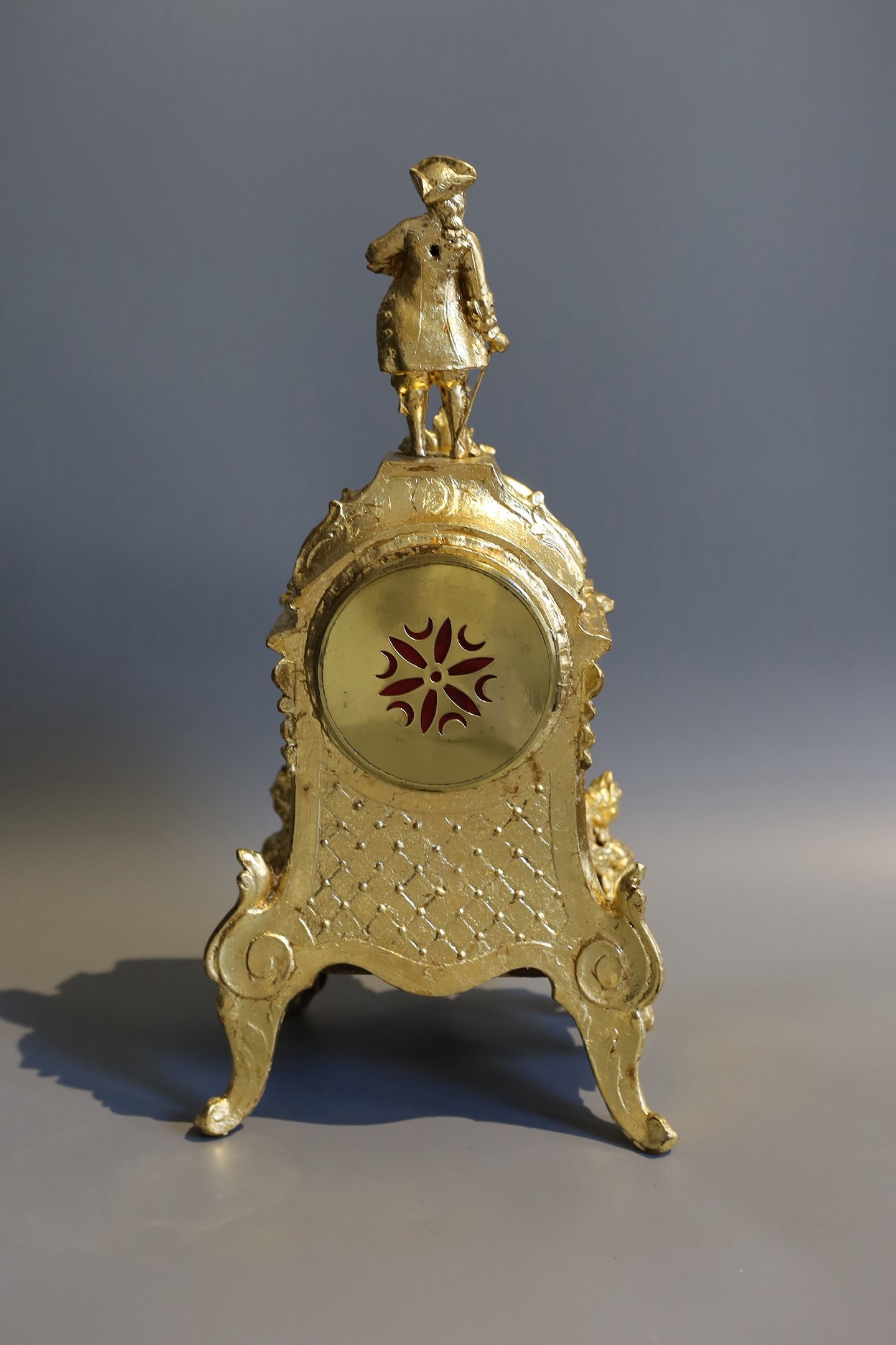 A 19th century French gilt metal and porcelain eight day mantel clock, with figural pediment, height 43cm